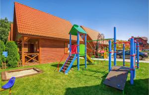 un parque infantil frente a una casa con tobogán en Beautiful Home In Dabki, Bobolin With Kitchen, en Bobolin