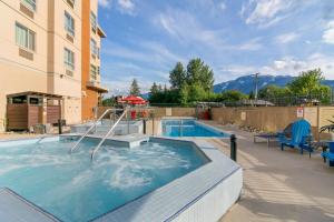uma piscina num hotel com montanhas ao fundo em Best Western Plus Revelstoke em Revelstoke