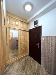 a room with a hallway with a door and a mirror at Apartment Njegoš in Perast