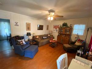 a living room filled with furniture and a ceiling fan at 11th St. Casa Blanca Bandera, TX. in Bandera