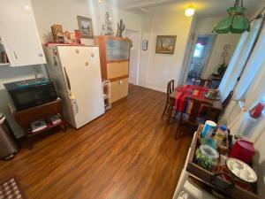 a kitchen and living room with a refrigerator and a table at 11th St. Casa Blanca Bandera, TX. in Bandera