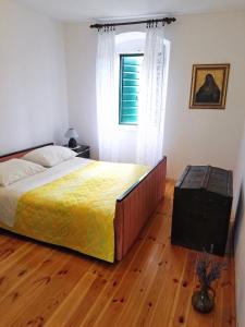 a bedroom with a large bed and a window at Holiday house with WiFi Dol, Brac - 5674 in Postira