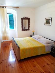 a bedroom with a bed with a yellow blanket at Holiday house with WiFi Dol, Brac - 5674 in Postira