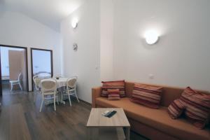a living room with a couch and a table at Apartments by the sea Vinjerac, Zadar - 5811 in Vinjerac