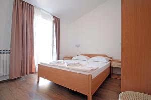 a bedroom with a bed and a large window at Apartments by the sea Vinjerac, Zadar - 5811 in Vinjerac