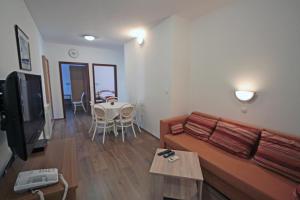 a living room with a couch and a table at Apartments by the sea Vinjerac, Zadar - 5811 in Vinjerac