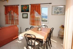 a dining room with a table and chairs and a couch at Apartments by the sea Sucuraj, Hvar - 5680 in Sućuraj