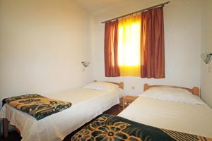 two beds in a room with a window at Apartments by the sea Vinjerac, Zadar - 5824 in Vinjerac