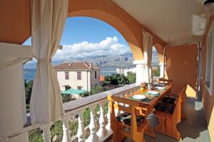 a balcony with a table and a view at Apartments by the sea Vinjerac, Zadar - 5824 in Vinjerac