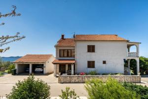 a large white house with red tile roofs at Family friendly seaside apartments Kozino, Zadar - 5756 in Petrcane