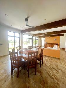 a dining room with a table and chairs and a bedroom at VILLA LA MARQUESA in Puerto Escondido