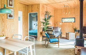 a living room with wood paneling and a dining room at Gorgeous Home In Nowe Warpno With Wifi in Nowe Warpno