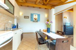 a kitchen and dining room with a table and chairs at Apartments with parking space Razanac, Zadar - 5885 in Ražanac