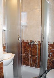 a bathroom with a shower with a sink and a toilet at Double Room Trstenik 4566c in Trstenik