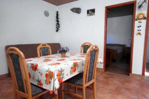 a table and chairs with a table cloth on it at Seaside secluded apartments Cove Tatinja, Hvar - 5729 in Vrbanj +26 photos