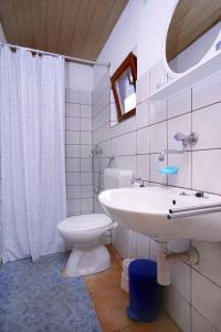 a bathroom with a sink and a toilet at Seaside secluded apartments Cove Tatinja, Hvar - 5729 in Vrbanj