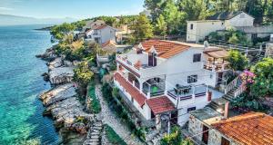 an aerial view of a house next to the water at Apartments by the sea Basina, Hvar - 5699 in Vrbanj
