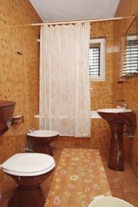a bathroom with two sinks and a shower at Apartments with a parking space Supetar, Brac - 5676 in Supetar