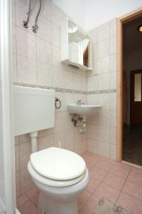 a bathroom with a toilet and a sink at Apartment Biograd na Moru 5899c in Biograd na Moru