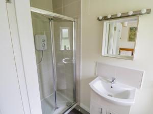 a bathroom with a shower and a sink at 2 Castle Cove in Drumahayre