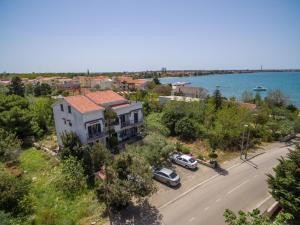 an aerial view of a house with cars parked on a street at Apartments and rooms by the sea Vrsi - Mulo, Zadar - 5848 in Vrsi
