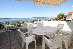 a table and chairs on a patio with a view of the ocean at Apartments by the sea Sukosan, Zadar - 5802 in Sukošan