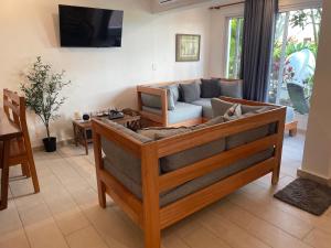 a living room with a couch and a tv at KITE BEACH Oceanfront LUXURY 1 BEDROOM - All new in 2022 in Cabarete
