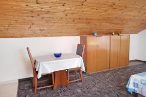 Zimmer mit einem Tisch, Stühlen und einem Schrank in der Unterkunft Studio Vrsi - Mulo 5796b in Vrsi