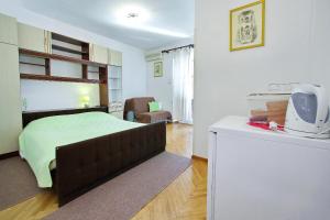 ein Schlafzimmer mit einem Bett und ein Wohnzimmer in der Unterkunft Apartments and rooms by the sea Zadar - 5874 in Zadar