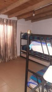 a room with two bunk beds and a window at Cabañas Lugar Escondido in Mendoza