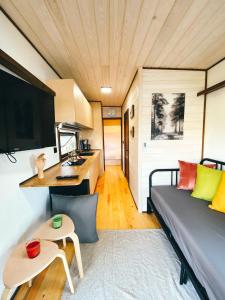 a living room with a couch and a table at Danzi camping tiny house in Rize