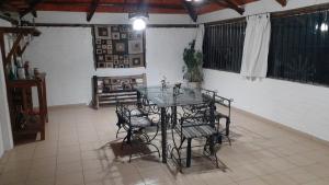 a dining room with a glass table and chairs at Cabañas Lugar Escondido in Mendoza