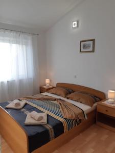 a bedroom with a bed with two towels on it at Apartments by the sea Vrsi - Mulo, Zadar - 5859 in Vrsi