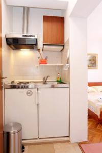 a small kitchen with a sink and a bed at Apartments by the sea Trstenik, Peljesac - 4570 in Trstenik