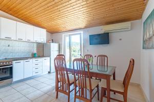 a kitchen with a dining room table and chairs at Apartments by the sea Cove Pokrivenik, Hvar - 4604 in Gdinj