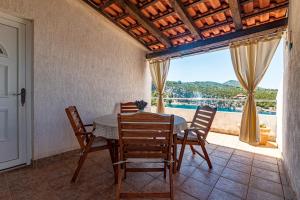 a dining room with a table and chairs and a window at Apartments by the sea Cove Pokrivenik, Hvar - 4604 in Gdinj