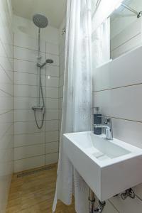 a white bathroom with a sink and a shower at Apartments by the sea Cove Pokrivenik, Hvar - 4604 in Gdinj