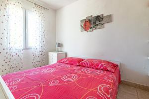 a bedroom with a pink bed and a window at Apartments by the sea Cove Pokrivenik, Hvar - 4604 in Gdinj