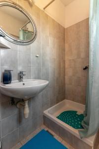 a bathroom with a sink and a tub and a mirror at Apartments by the sea Cove Pokrivenik, Hvar - 4604 in Gdinj