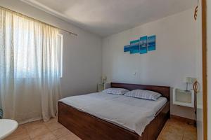 a bedroom with a bed and a sink and a window at Apartments by the sea Cove Pokrivenik, Hvar - 4604 in Gdinj