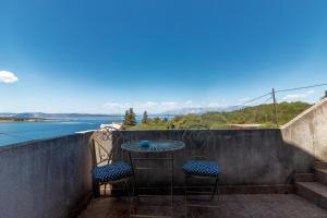 a table and chairs on a balcony with a view of the water at Apartments by the sea Cove Pokrivenik, Hvar - 4604 in Gdinj
