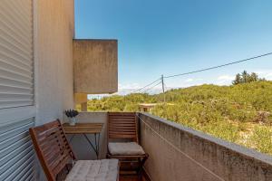 a balcony with a bench and a table on it at Apartments by the sea Cove Pokrivenik, Hvar - 4604 in Gdinj
