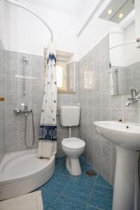 a bathroom with a white toilet and a sink at Apartments by the sea Lumbarda, Korcula - 4358 in Lumbarda +22 photos
