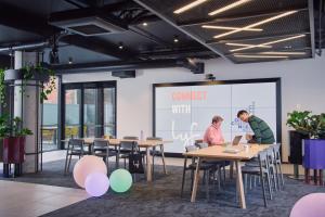 two people in a conference room with tables and chairs at lyf Collingwood Melbourne in Melbourne