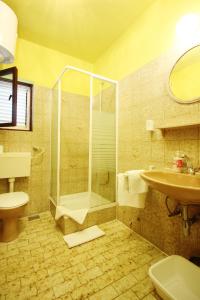 a bathroom with a shower and a toilet and a sink at Family friendly seaside apartments Orebic, Peljesac - 4537 in Orebić