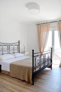 a bedroom with a bed and a large window at Apartments and rooms by the sea Orebic, Peljesac - 4563 in Orebić
