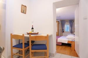 a room with a table with a bottle of wine at Apartments with a parking space Omis - 4327 in Omiš