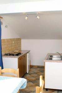 a kitchen with a sink and a counter top at Apartment Vlasici 4319a in Vlašići