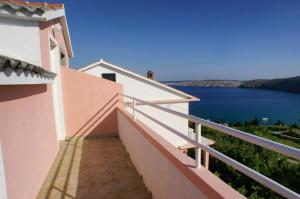 a balcony of a house with a view of the water at Apartment Vlasici 4319a in Vlašići