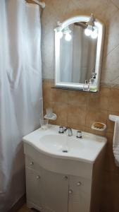 a bathroom with a white sink and a mirror at Casita Cavok in San Carlos de Bariloche +9 photos
